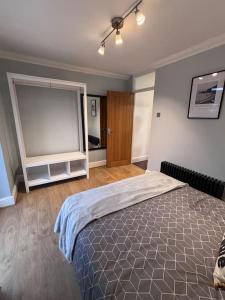 a bedroom with a bed and a large window at Priory park view in Southend-on-Sea