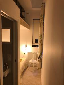 a small room with a bed and a chair at Au coeur de Bordeaux in Bordeaux