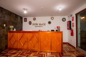 a wooden counter in a room with a wall at INYAWASI APARTMENT in Cusco