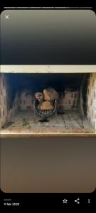 un horno de ladrillo con un poco de pan en un estante en OLIEMI en El Calafate