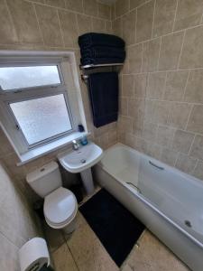 a bathroom with a toilet and a tub and a sink at city centre - 2 bed house, parking for 2 in Cardiff
