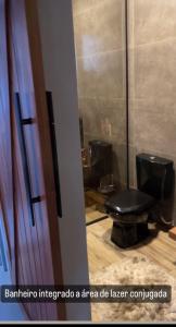 a bathroom with two black toilets in a room at Refúgio nascer das águas in Gravatal