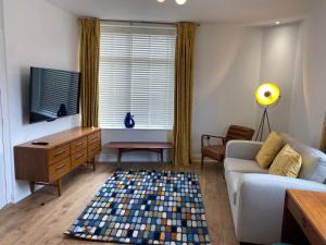 a living room with a couch and a tv at No.1 Clement House in York