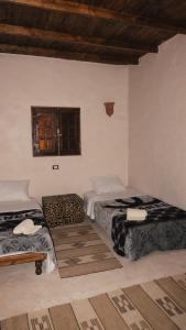 a room with two beds and a window at Stamps Siwa Oasis in Siwa