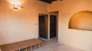 an empty room with a bench and a door at Stamps Siwa Oasis in Siwa