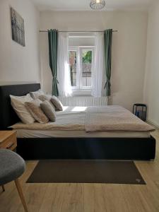 a large bed in a bedroom with a window at City centre room in Zagreb