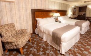 Giường trong phòng chung tại Hotel Plaza San Martin