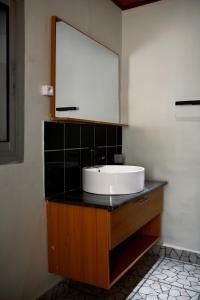 a bathroom with a sink and a mirror at KC GuestHouse in Yaoundé