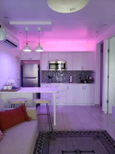 a kitchen with purple lighting in a room at The Palm Retreat Buye, Playa Buyé in El Cerro