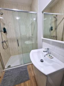 ein Bad mit einem Waschbecken und einer Dusche in der Unterkunft Portrush by the Sea - 1 Golf Terrace in Portrush