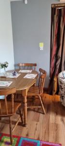 ein Esszimmer mit einem Holztisch und Stühlen in der Unterkunft Cute loft apartment sleeps 4 in Antrim