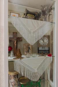 a shelf with a cross and a clock in a room at Casa de la Judería Doña Pilar in Seville