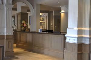 a lobby with a counter with flowers on it at Best Western Inverness Palace Hotel & Spa in Inverness