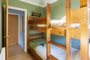 a couple of bunk beds in a room at Rambler’s Retreat in Dersingham