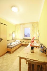 a large room with a bed and a table in it at Double Room in Hütteldorfer Straße Area in Vienna