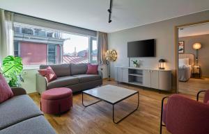 a living room with a couch and a tv at Scandic Europa in Gothenburg