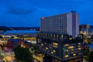 a tall building with lights on in a city at Pittsburgh Marriott City Center in Pittsburgh