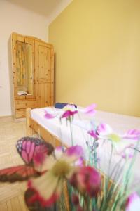 a bedroom with a bed with flowers in the foreground at Double Room in Hütteldorfer Straße Area in Vienna