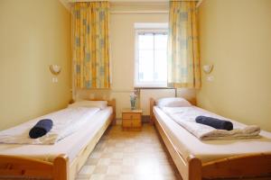 two beds in a room with a window at Double Room in Hütteldorfer Straße Area in Vienna