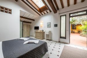 a bedroom with a bed and a large window at Cortile Santa Monaca in Florence