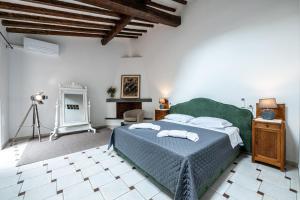 a bedroom with a bed with two towels on it at Cortile Santa Monaca in Florence