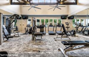 a gym with treadmills and exercise equipment on the floor at Hidden Gem at Med Center 2BR & 2BA Apartment in Houston