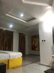 a bedroom with a bed and a painting on the wall at DAVIZZ HOTEL AND SUITES in Asaba