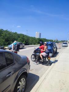 a group of people riding a motorcycle on the road at Habitación en Apartamento cartagena de indias in Cartagena de Indias