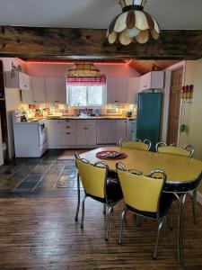 a kitchen with a table and chairs in it at Spry Church Cozy Cottage in Lions Head