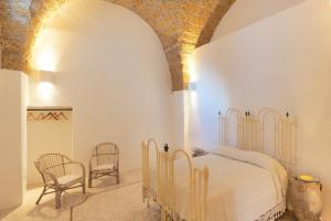 A bed or beds in a room at Holiday home La Corte dei Pirri