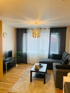 a living room with a couch and a coffee table at Noah Longstay Skellefteå in Skellefteå