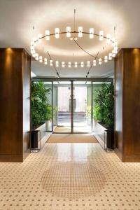 a hallway with a chandelier in a building at Radisson Collection Hotel, Roma Antica in Rome