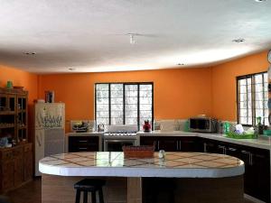 a kitchen with an island in the middle of it at Casa de campo en Teziutlán, Puebla. in Teziutlán