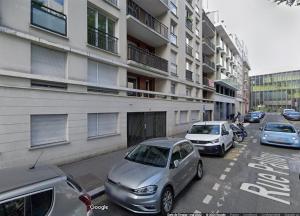 a street with cars parked in front of a building at Studio à 2 pas du métro in Clichy