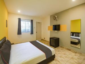 a bedroom with a large bed and a window at Map Inn in Morjim