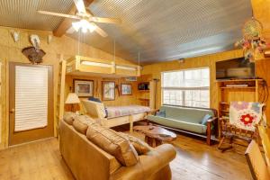 a living room with a couch and a bed at Cozy Riverfront Cabin about 2 Mi to Main Street Hardy in Hardy