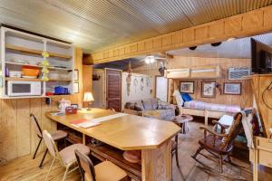 a kitchen and living room with a table and chairs at Cozy Riverfront Cabin about 2 Mi to Main Street Hardy in Hardy