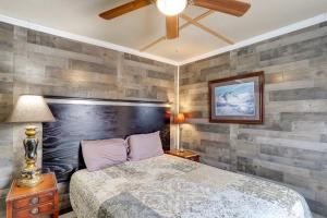 a bedroom with a bed and a wooden wall at Historic Hardy Home with Game Room on Main Street in Hardy
