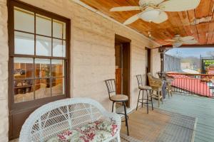 a porch with chairs and a ceiling fan at Historic Hardy Home with Game Room on Main Street in Hardy