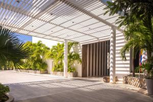 a pavilion with palm trees in a building at Santa Marta Marriott Resort Playa Dormida in Santa Marta