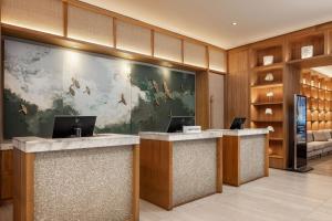 a lobby with two desks with laptops on them at Santa Marta Marriott Resort Playa Dormida in Santa Marta +193 photos