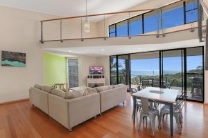 a living room with a couch and a table at Aaronvale in Point Lookout