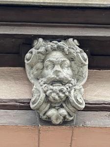 a stone face on the side of a building at Apartament na Przedmieściu in Wrocław