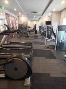 a gym with a toilet in the middle of a room at Saint Honore Executive: 6 guests, 5 beds, 2 bedrooms, 2 bathrms in Iloilo City