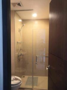 a bathroom with a glass shower with a toilet at Saint Honore Executive: 6 guests, 5 beds, 2 bedrooms, 2 bathrms in Iloilo City
