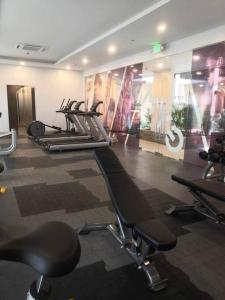 a gym with a row of exercise bikes in a room at Saint Honore Executive: 6 guests, 5 beds, 2 bedrooms, 2 bathrms in Iloilo City