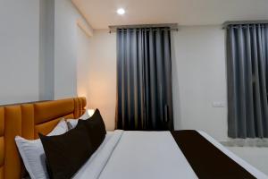 a bedroom with a large bed with black curtains at Townhouse 1338 The Cinco Bliss in Hyderabad