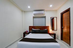 a bedroom with a white bed and a window at Townhouse 1338 The Cinco Bliss in Hyderabad
