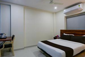 a bedroom with a bed and a desk and a bed sidx sidx sidx at Townhouse 1338 The Cinco Bliss in Hyderabad