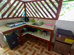 a small kitchen with a sink in a play house at Alouatta Hanging Bridges Adventure and Lodge in Cahuita